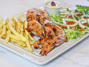 Grilled Mediterranean Prawns with salad, chips & home made sauce